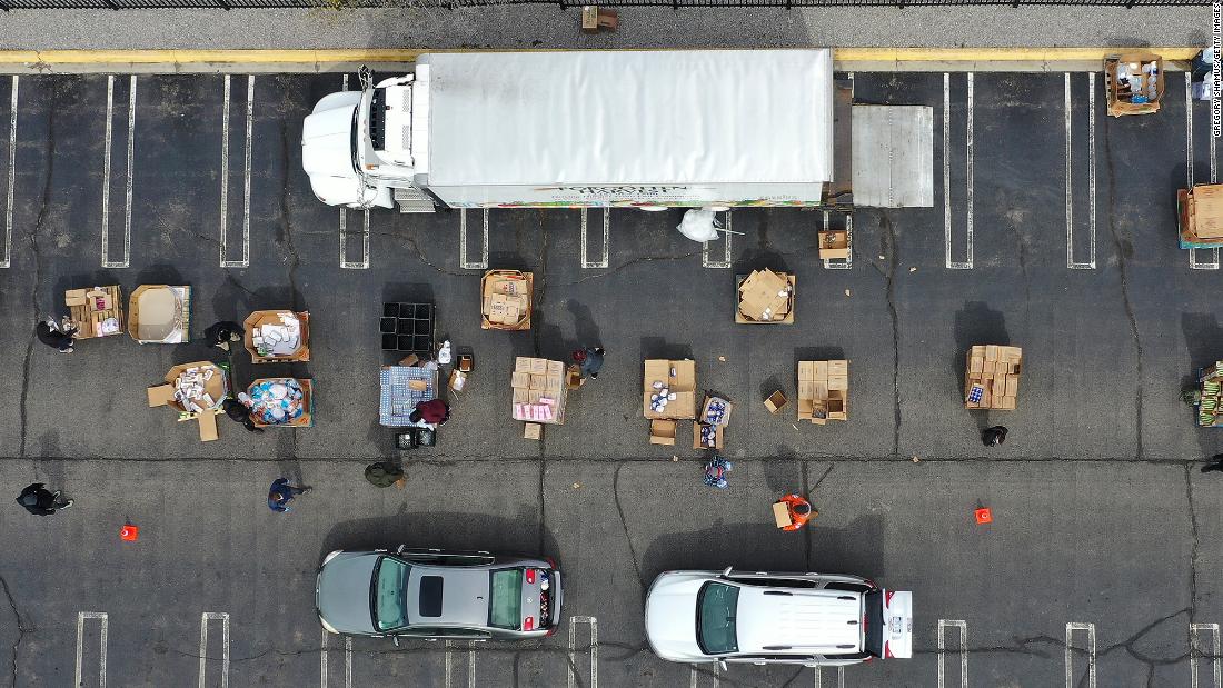 Volunteers with Forgotten Harvest load food into vehicles at a mobile pantry in Detroit.