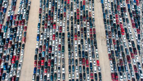 People wait in their cars Thursday, April 9, 2020, at Traders Village for the San Antonio Food Bank to begin food distribution. The need for emergency food aid has exploded in recent weeks due to the coronavirus epidemic. (William Luther/The San Antonio Express-News via AP)