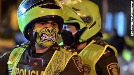 Police officers wearing colorful face masks in Cali, Colombia on March 20 as preventative measures began. 