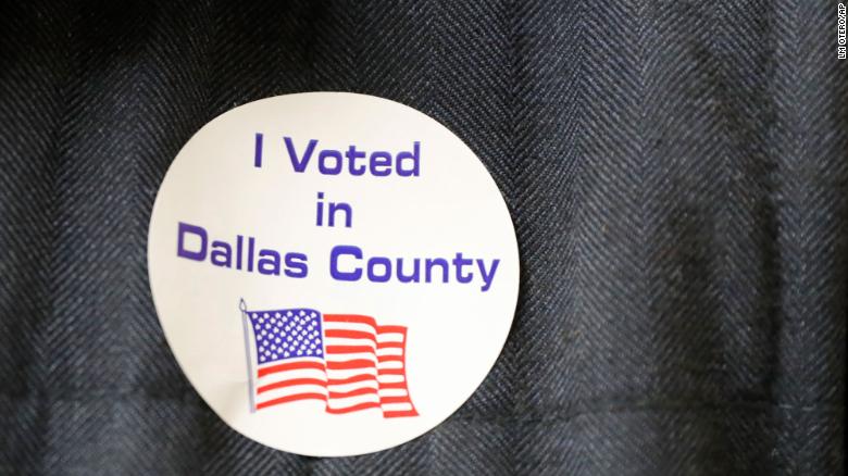 Democrat Jamie Wilson displays a sticker after voting in the Super Tuesday primary at John H. Reagan Elementary School in the Oak Cliff section of Dallas, Tuesday, March 3, 2020. (AP Photo/LM Otero)