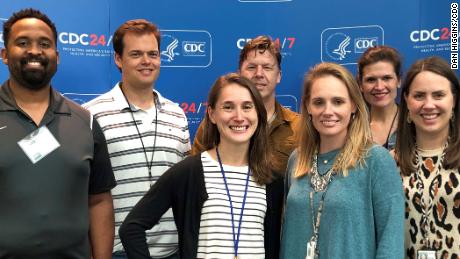 Alissa Eckert, front row in green sweater, and Dan Higgins, back row in white polo shirt, created the coronavirus illustration for the CDC.