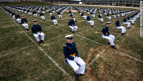 Air Force Academy cadets, spaced 8 feet apart, listen to a commencement address by Vice President Mike Pence Saturday.