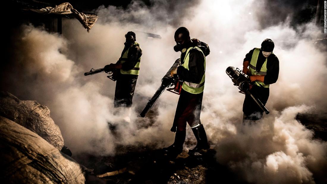 Workers in Nairobi, Kenya, fumigate the streets and the stalls of the City Park Market.