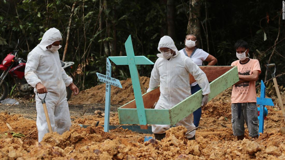 Funeral workers in Manaus, Brazil, prepare the grave of a woman who was suspected to have died from the coronavirus.