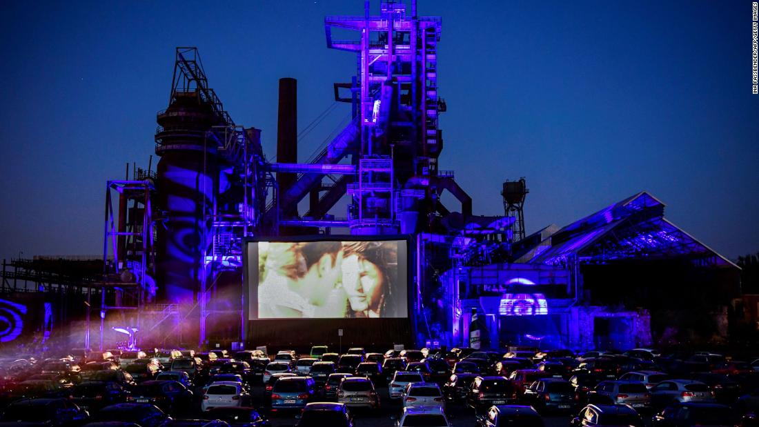 Cars sit at a newly opened drive-in cinema in Dortmund, Germany, on April 17, 2020. It was in front of a former blast furnace.