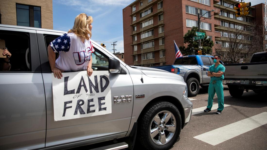 A health care worker stands in a Denver street on April 19 to &lt;a href=&quot;http://www.cnn.com/2020/04/20/us/coronavirus-colorado-health-care-trnd/index.html&quot; target=&quot;_blank&quot;&gt;counterprotest&lt;/a&gt; the hundreds of people who were demanding that stay-at-home orders be lifted.