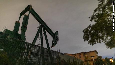 Pump jacks draw crude oil from the Long Beach Oil Field near homes in Signal Hill, California, on March 9, 2020. - Global stocks and oil prices rebounded on March 10, 2020 on hopes of US economic stimulus efforts as the coronavirus rages, one day after suffering their biggest losses in more than a decade. Trading is exceptionally volatile as investors attempt to get a grip on a rapidly changing news flow, with positive reports of progress in China on the virus clashing with a Saudi decision to increase oil output in an already over-supplied market. (Photo by David McNew/AFP/Getty Images)