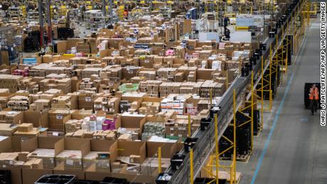 Workers prepare customer orders for dispatch as they work around goods stored inside an Amazon.co.uk fulfillment centre in Peterborough, central England, on November 15, 2017. - Shops could be seeing the effect of consumers postponing purchases until &quot;Black Friday&quot; on November 24, 2017, a day of sales in the United States that has become increasingly popular in Britain. (Photo by CHRIS J RATCLIFFE / AFP)        (Photo credit should read CHRIS J RATCLIFFE/AFP via Getty Images)