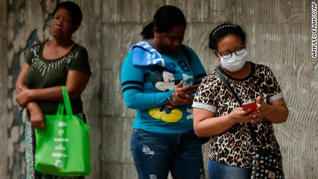 Women wait in line to enter a grocery store, on a day that men must stay indoors in Panama City after the authorities assigned men and women three different days a week on which they can leave home for essential business.