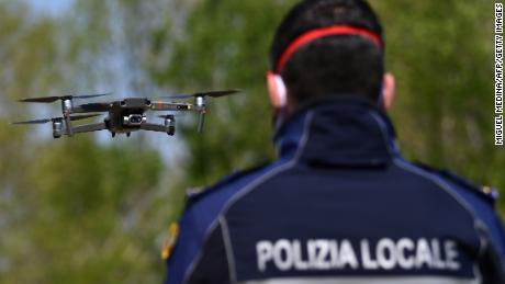 A police officer pilots a DJI Mavic 2 Enterprise drone with a thermal sensor for checking people&#39;s temperature on April 9 in Treviolo, near Bergamo, Italy.