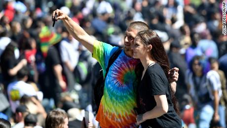 People take a selfie as thousands gather on Hippie Hill in San Francisco, Friday, April 20, 2018. Thousands of people flocked to Hippie Hill for the annual 420 celebration of all things pot and the number that is stoners&#39; code for smoking marijuana. Events also were held in other cities worldwide. (AP Photo/Josh Edelson)