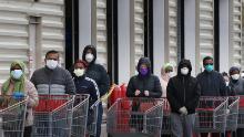 WHEATON, MARYLAND - APRIL 16: Customers wear face masks to prevent the spread of the novel coronavirus as they line up to enter a Costco Wholesale store April 16, 2020 in Wheaton, Maryland. Maryland Governor Larry Hogan ordered that all people must wear some kind of face mask to protect themselves and others from COVID-19 when on public transportation, grocery stores, retail establishments and other places where social distancing is not always possible. (Photo by Chip Somodevilla/Getty Images)