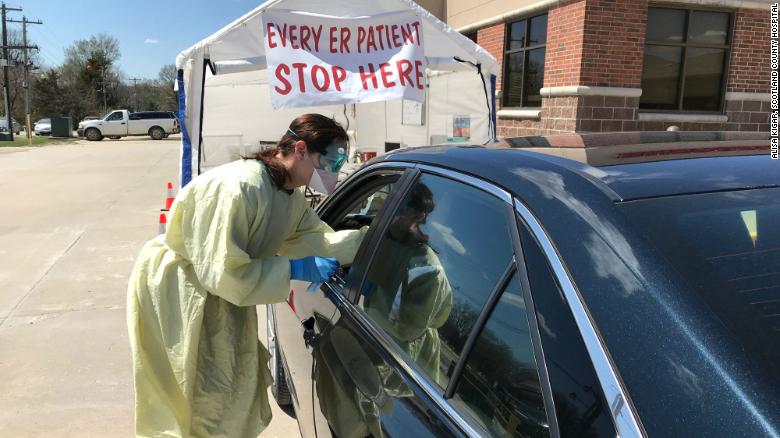 A nurse conducts a COVID-19 test in the drive thru site at Scotland County Hospital in Memphis, Missouri.