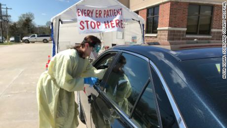 A nurse conducts a COVID-19 test in the drive thru site at Scotland County Hospital in Memphis, Missouri.