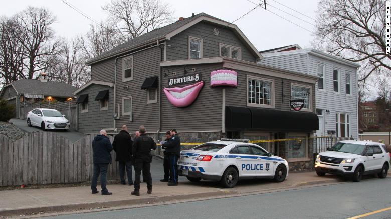 Investigators gather outside Nova Scotia clinic owned by the gunman who police said was responsible for a killing spree.