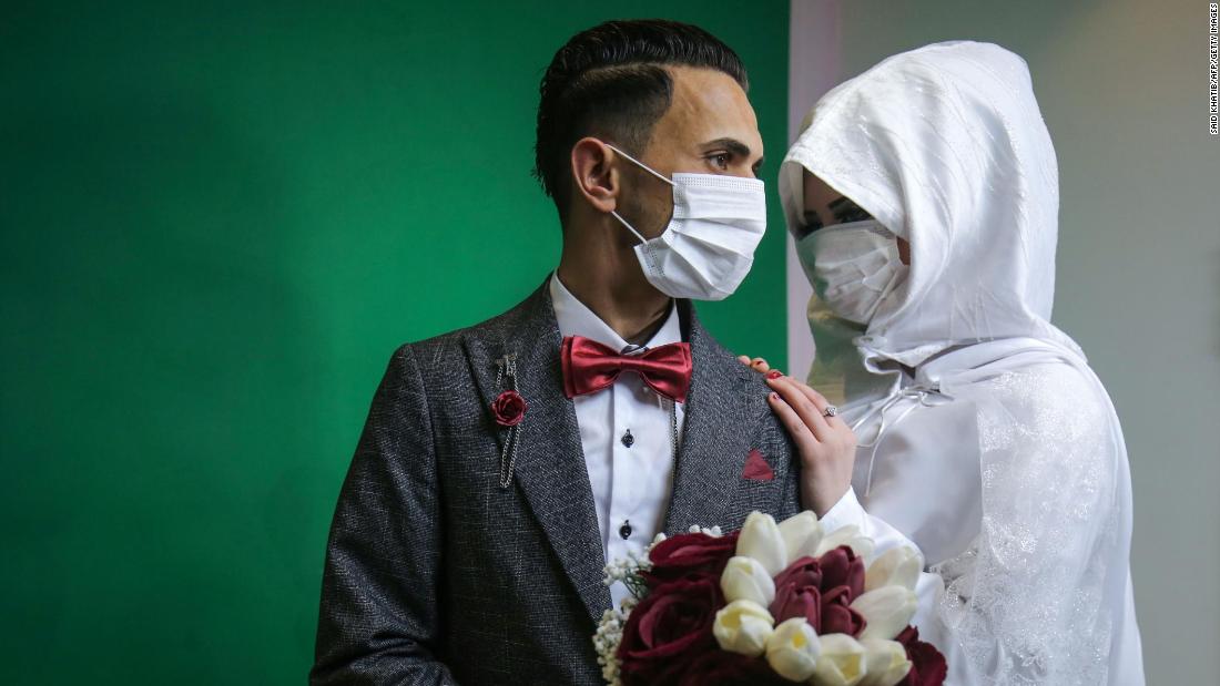 Mohamed Abu Daga and his bride, Israa, pose for photos before their wedding ceremony in Khan Yunis, Gaza, on March 23.