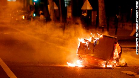 A trash can burns in the street during clashes in Villeneuve-la-Garenne, in the northern suburbs of Paris, early on April 21.