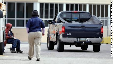 The pickup truck arrives, with bodies under the mats in the cargo bed, at a space near the Joseph W. Spellman Medical Examiner Building in University City on April 19