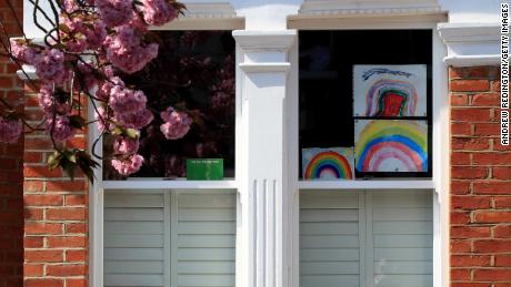 Homemade drawings of a rainbow are pictured in a window on April 9 in London, England.