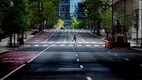 A woman runs through the empty streets in Washington, DC, on April 18.