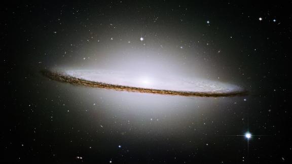 It's called one of the most photogenic galaxies: The Sombrero Galaxy looks like the giant broad rim of a Mexican hat sitting out among the stars. It can be spotted using a small telescope. It's about 28 million light years from Earth.