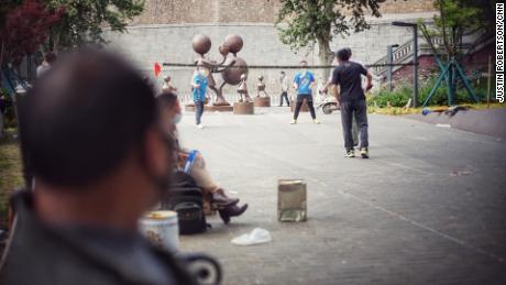 A group of Wuhan citizens come together to play badminton in a park after lockdown on April 23.