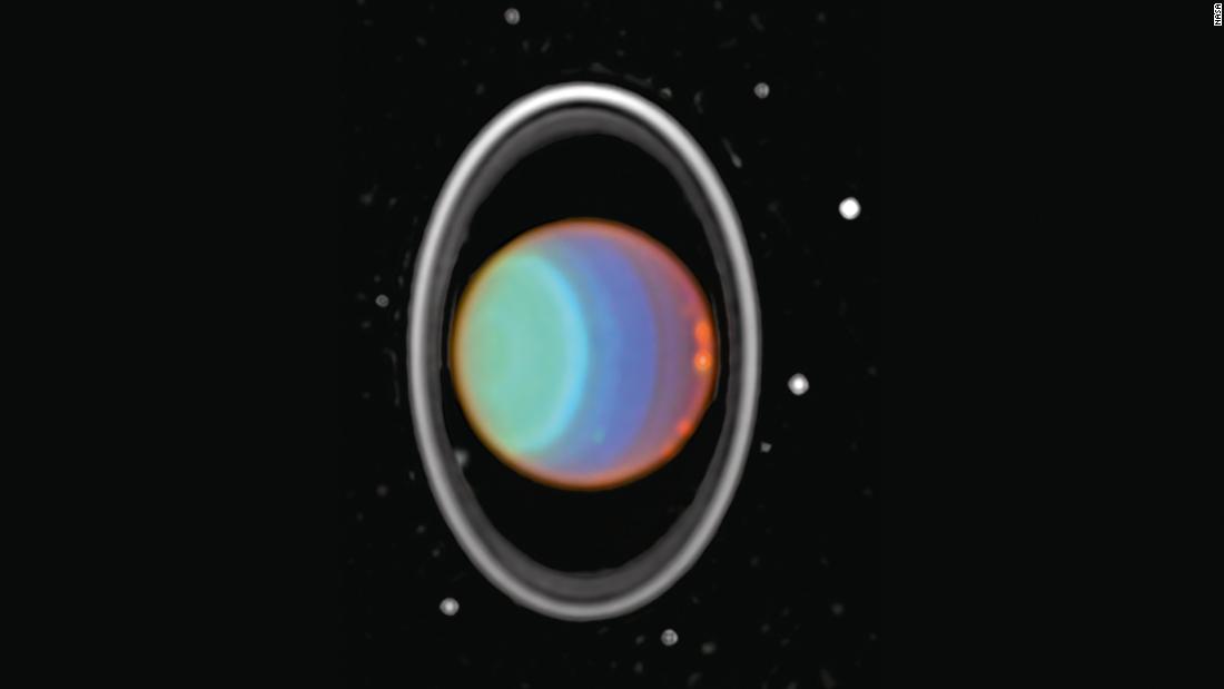 Hubble tracked clouds on Uranus in this image taken in 1997. The image is a composite of three near-infrared images. The planet&#39;s rings are prominent in the near infrared. Eight of Uranus&#39; 27 moons can be seen in both images. Uranus is about 1.75 billion miles from Earth.