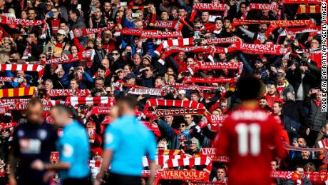 LIVERPOOL, ENGLAND - MARCH 07: Fans of Liverpool hold up scarves during the Premier League match between Liverpool FC and AFC Bournemouth  at Anfield on March 7, 2020 in Liverpool, United Kingdom. (Photo by Robbie Jay Barratt - AMA/Getty Images)