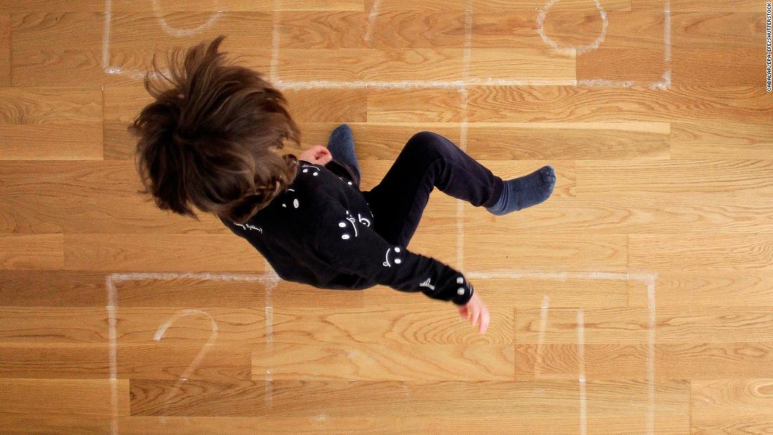 A boy plays hopscotch at his home in A Coruna, Spain. 