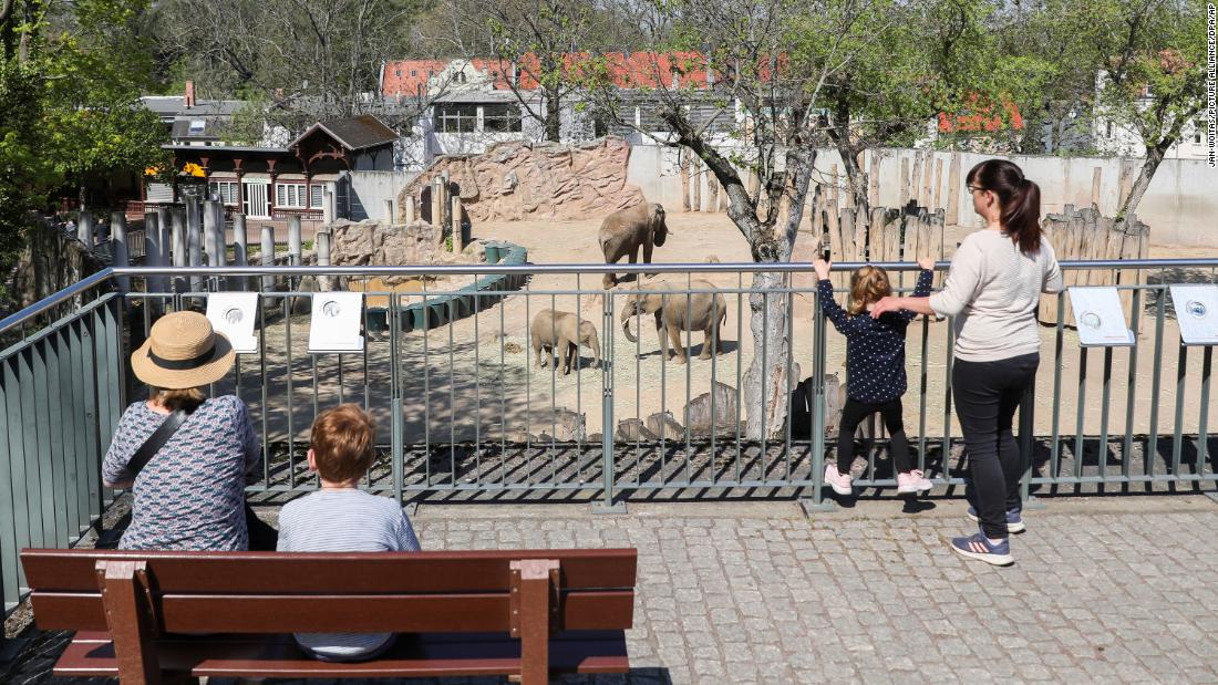 Visitors maintain their distance outside the elephant enclosure at Bergzoo Halle in Saxony-Anhalt, Germany, on April 23. Under strict conditions, zoos in Saxony-Anhalt were allowed to reopen after being closed for several weeks.