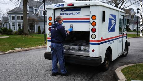 US Postal Service worker Lou Martini goes about his daily delivery route during the coronavirus pandemic on April 15, in Kings Park, New York. 