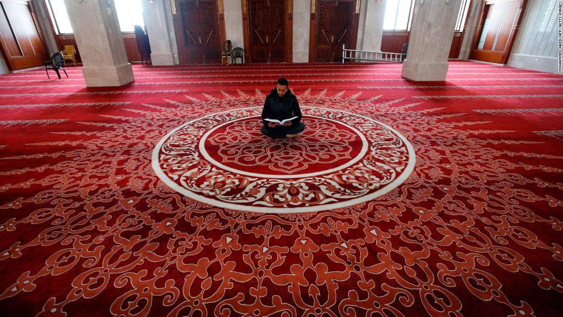 A muezzin, the person at a mosque who calls Muslims to daily prayers, reads the Quran at a mosque in Gaza City after &lt;a href=&quot;http://www.cnn.com/2020/04/23/world/gallery/ramadan-2020/index.html&quot; target=&quot;_blank&quot;&gt;Ramadan began&lt;/a&gt; on April 24, 2020.