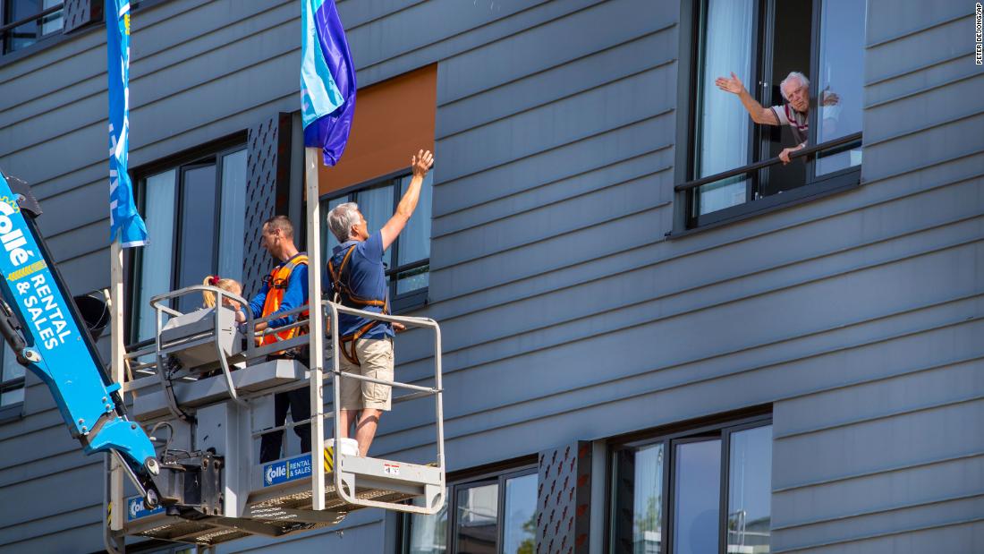 Pitrik van der Lubbe waves from a boom lift to his 88-year-old father, Henk, at his father&#39;s nursing home in Gouda, Netherlands. Pitrik had not seen his father in more than four weeks.