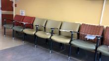 A row of seats in a hospital waiting room are taped off so patients won&#39;t sit in them. It&#39;s a social distancing measure other health care providers have taken. 
