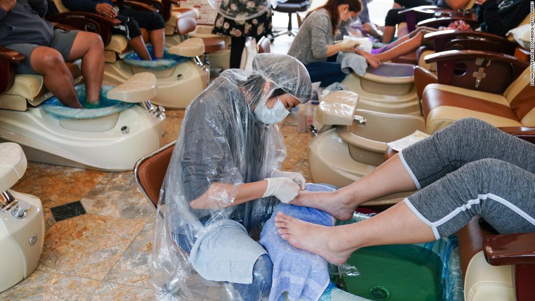 Technicians give pedicures to customers at a nail salon in Atlanta on April 24.
