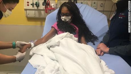 Alyssa Jennings, 11, of Prince George&#39;s County, Maryland, has a rare blood disease. Here, two health care workers tend to Alyssa in Inova Fairfax Children&#39;s Hospital.