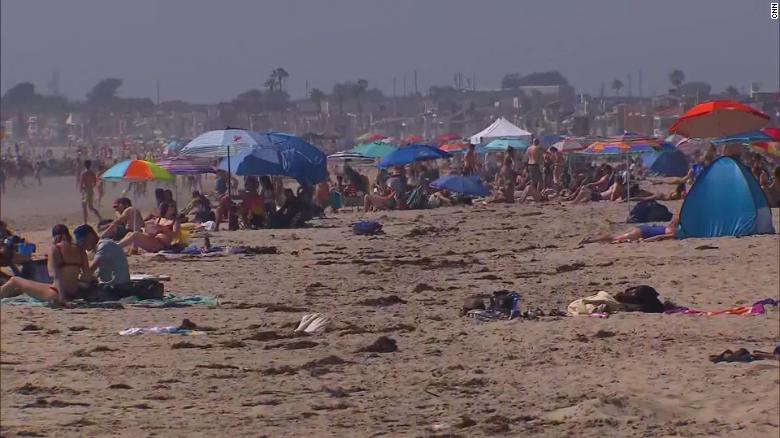 Contrasting images as some California beaches reopen
