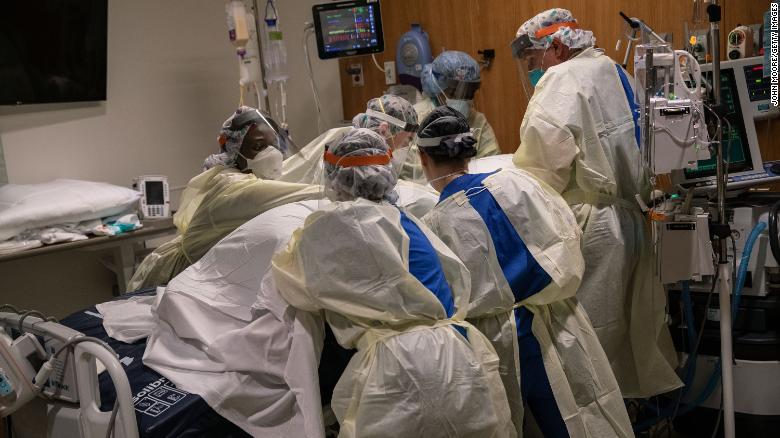 A &quot;prone team,&quot; wearing personal protective equipment (PPE), turns a COVID-19 patient onto his stomach in a Stamford Hospital intensive care unit (ICU), on April 24, 2020 in Stamford, Connecticut. The civilian/military team, made up of physical and occupational therapists turns over COVID-19 patients to help their labored breathing and increase lung capacity. Stamford Hospital, like many across the US, opened additional ICUs and have been augmented by military medical personnel to deal with the heavy patient load. Stamford, with it&#39;s close proximity to New York City, has the highest number of coronavirus patients in Connecticut.