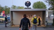 Employees walk towards an entrance gate at the Volkswagen plant in Wolfsburg, Germany, on April 27, 2020. 