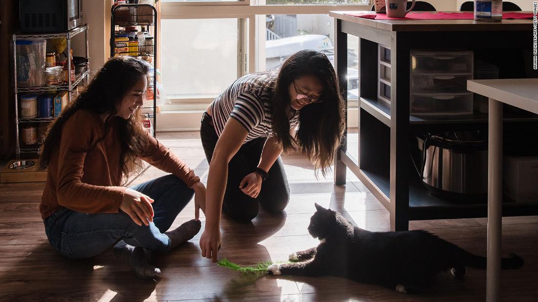 Morgan Miller (left) and Sarah Chan (right) play with Silvia, age 6, in their apartment in San Diego&#39;s Pacific Beach neighborhood. 