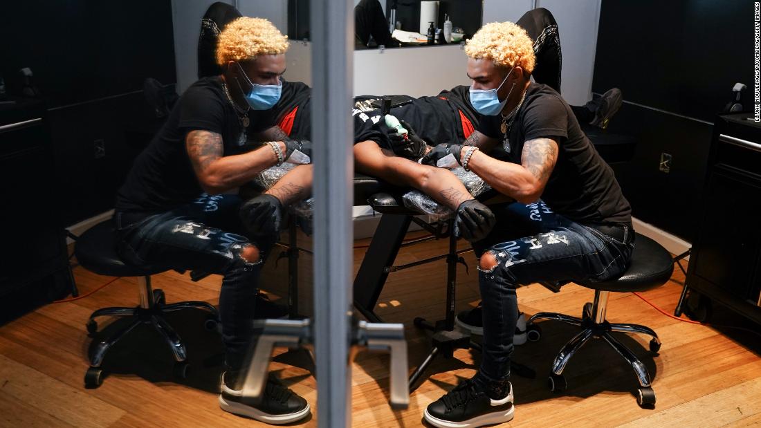 A tattoo artist works on a customer in Atlanta on April 24. Despite criticism, Gov. Brian Kemp of Georgia &lt;a href=&quot;https://www.cnn.com/2020/04/24/us/georgia-coronavirus-reopening-businesses-friday/index.html&quot; target=&quot;_blank&quot;&gt;allowed tattoo parlors and some other nonessential businesses to reopen.&lt;/a&gt;