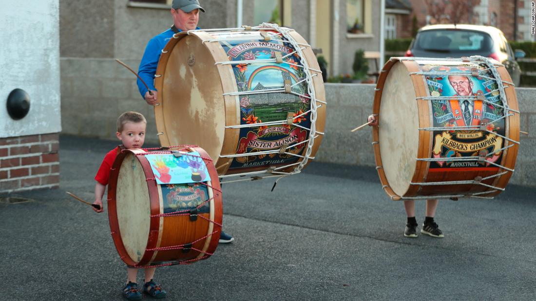 Mark Black and his sons, Thomas and Adam, play Lambeg drums outside their home in County Armagh, Northern Ireland, during the weekly &quot;Clap for our Carers&quot; on April 16.