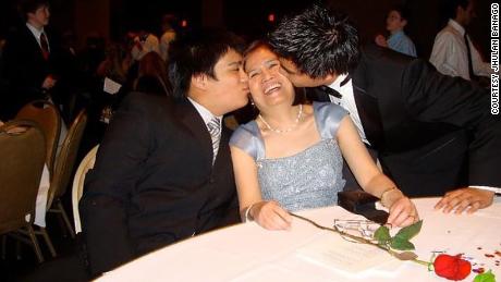 Celia Yap-Banago (center) with her two sons, Jhulan (right) and Josh. 