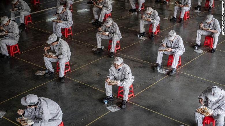 Employees on a lunch break at an auto plant of Dongfeng Honda in Wuhan, China on March 23.