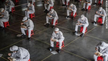 Employees on a lunch break at an auto plant of Dongfeng Honda in Wuhan, China on March 23.