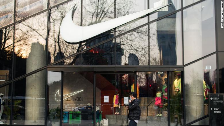 A pedestrian walking by a Nike store in Shanghai in March.