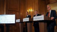 Boris Johnson, center, is flanked by England Chief Medical Officer Chris Whitty, left, and Chief Scientific Advisor Patrick Vallance at a press conference on March 12.