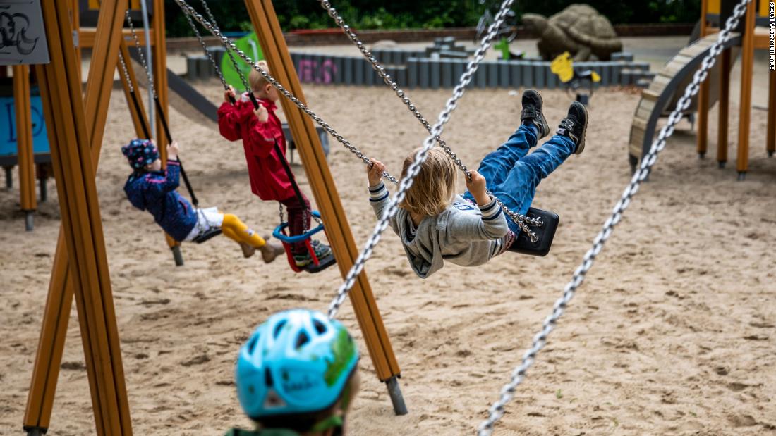 Children play on a public playground in Berlin on April 30. Many playgrounds were reopening for the first time.