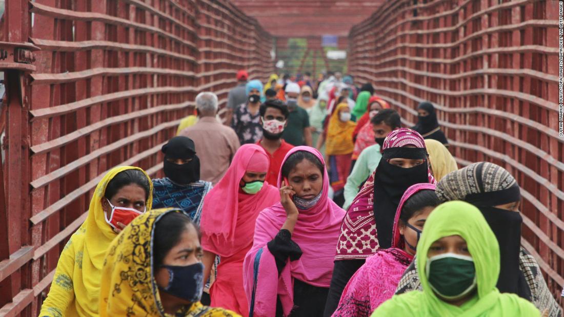 Garment workers wear face masks as they return to work in Dhaka, Bangladesh, on April 30. More than 500 garment factories in Bangladesh reopened.