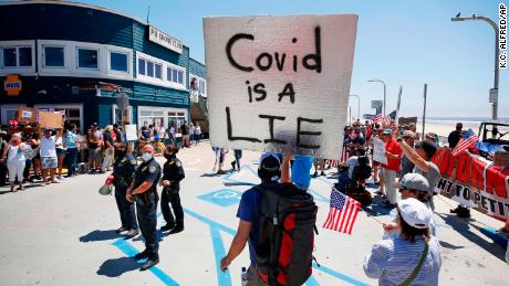 A protester claims Covid-19 is a lie. But it's killed more people than the flu this past year.